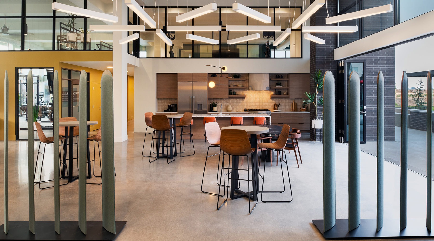 Large well lit clubhouse with plenty of seating and large windows 